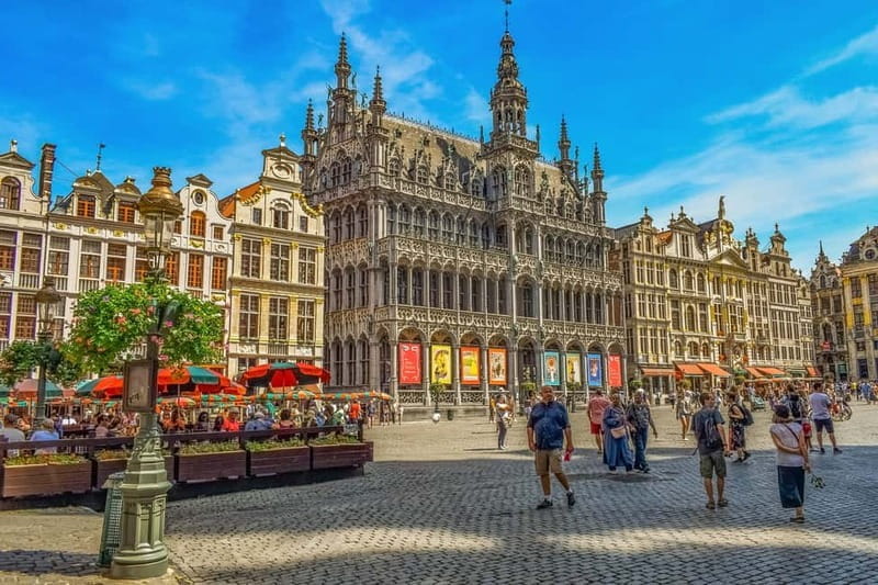Brussels Highlights: Walking & Bus Tour with Waffle Tasting - Entering the Heart of Brussels: The Grand Place and Nearby Sights