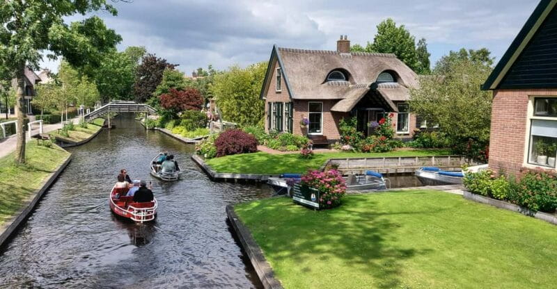 From Amsterdam: Giethoorn Small Group Tour with Boat Ride - Walking Through the Village: Bridges, Cottages, and Stories