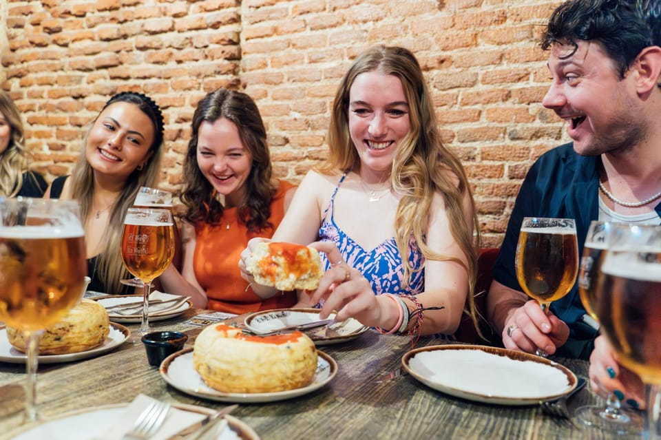 Madrid: Tapas Crawl Food Tour With 6 Tapas and 4 Drinks - Guide and Meeting Point