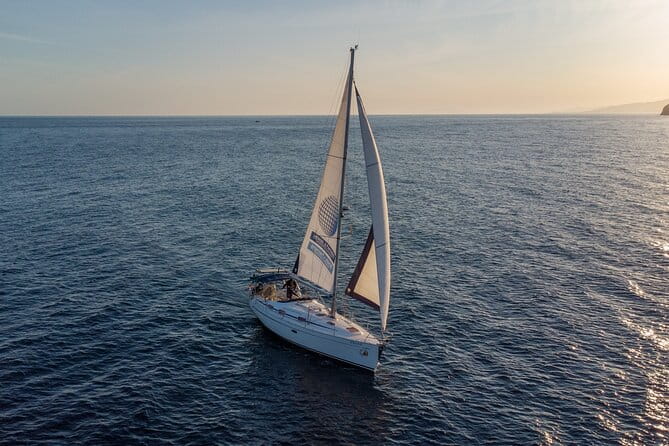Sailing at sunset along the cliffs of Maro-Compartida - The Sum Up: A Small-Group Coastal Escape Worth Considering